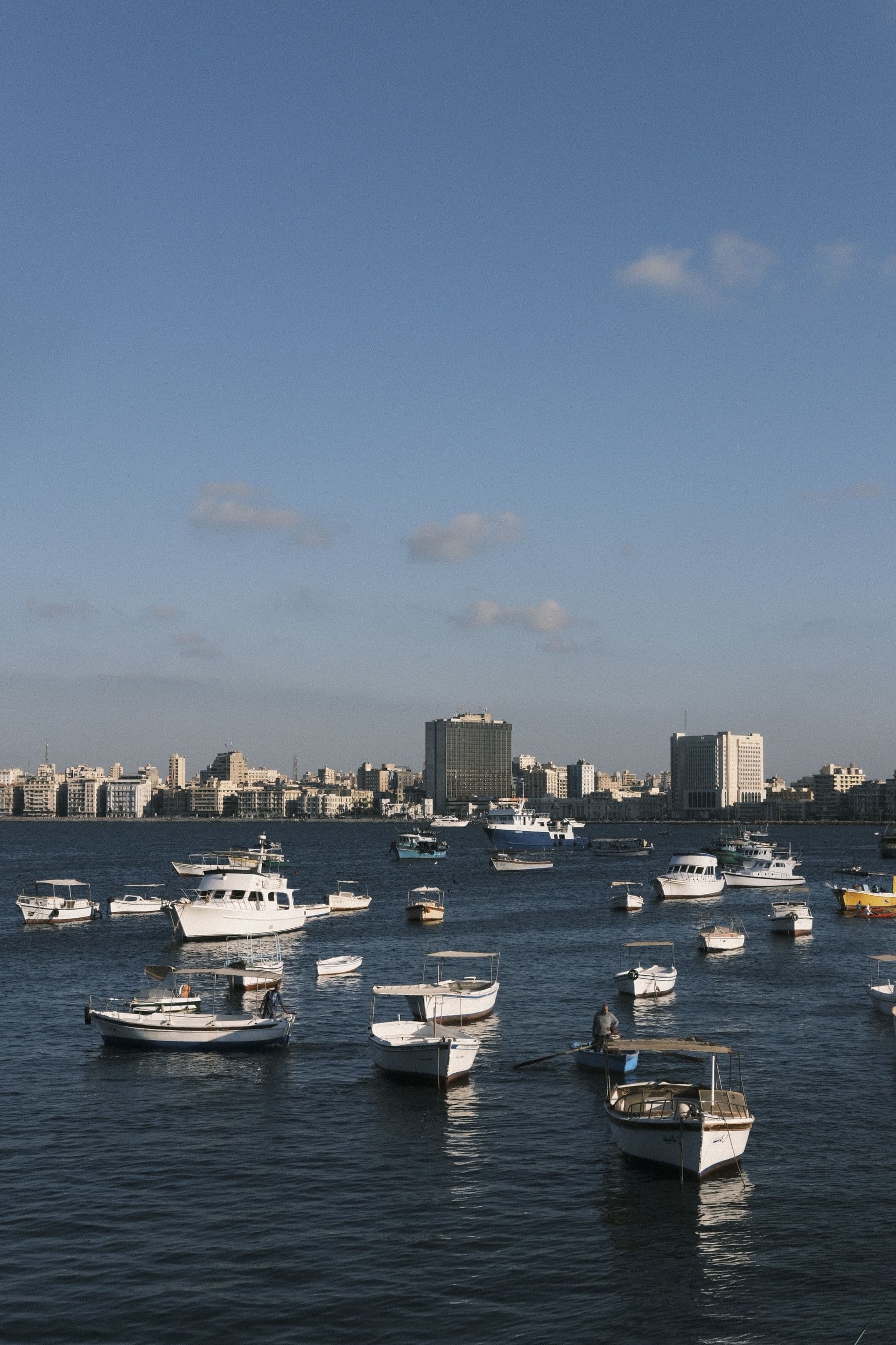 The Nile at golden hour with a felucca sailboat and the Cairo skyline